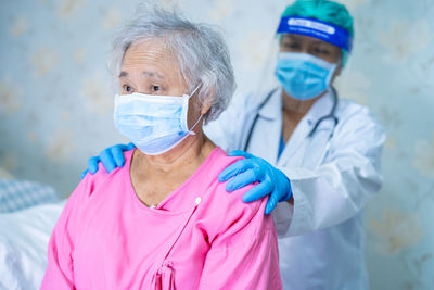 Midsection of man with woman wearing mask