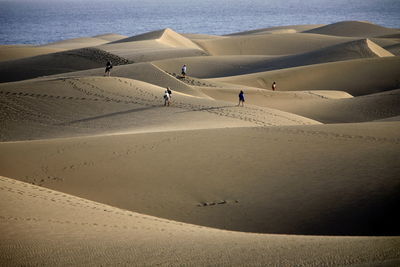 High angle view of people on desert against sea