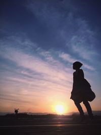 Silhouette of woman at sunset