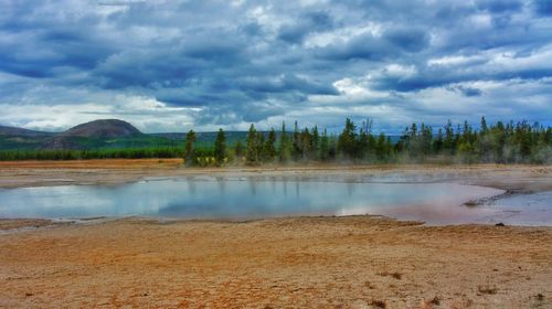 Scenic view of lake against cloudy sky