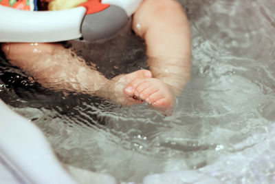 Close-up of woman hands in bathtub