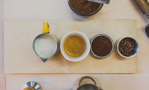 High angle view of coffee and cups on table