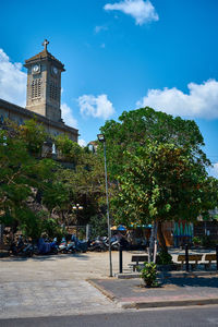 Trees and buildings against sky