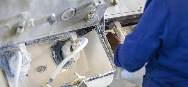 Man working on metal grate