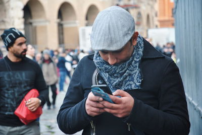 Man using mobile phone in city