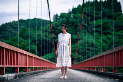 Woman standing on bridge