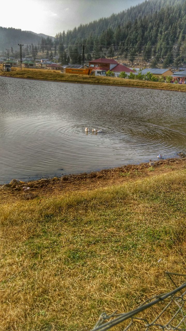 water, tranquility, tranquil scene, grass, lake, transportation, river, nature, scenics, landscape, beauty in nature, high angle view, sky, day, riverbank, plant, field, mode of transport, outdoors, no people