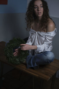 Young woman sitting at home