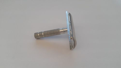 High angle view of metal on table against white background