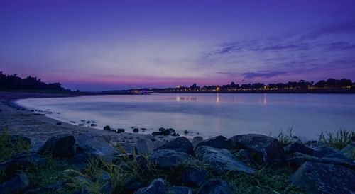 Scenic view of lake against sky at sunset