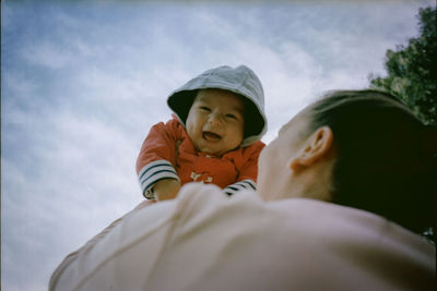 Low angle view of woman holding baby