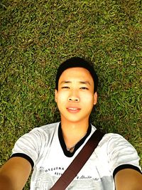 Portrait of boy smiling on field
