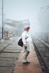 Full length of woman walking on road against sky