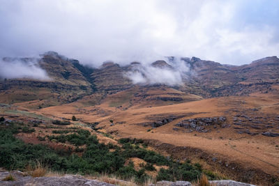 Scenic view of arid landscape against sky