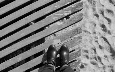 Low section of person standing on tiled floor