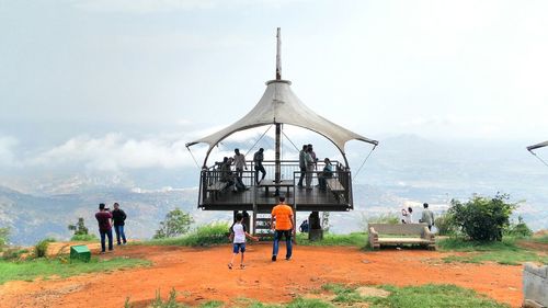 People at observation point against sky