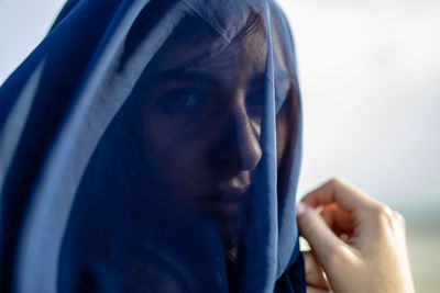 Close-up of woman covered with navy blue textile