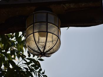 Low angle view of electric lamp against sky