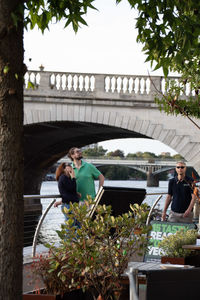 Woman sitting on bridge