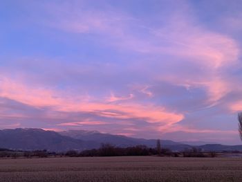 Scenic view of field against sky during sunset