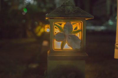 Close-up of illuminated lighting equipment on glass