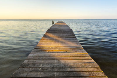 Pier over sea against clear sky