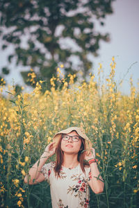 Woman standing by flowering plants