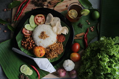 High angle view of fruits and leaves on table