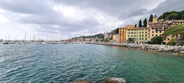 Panoramic view of sea and buildings against sky