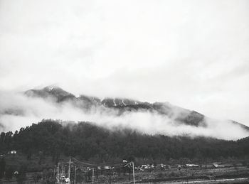 Scenic view of mountains against cloudy sky