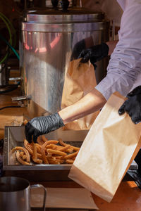 People preparing churros with chocolate in the street of spain