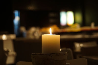 Close-up of lit candles on table in temple