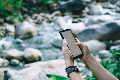 Midsection of man using mobile phone