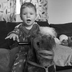 Young boy on rocking horse, black and white