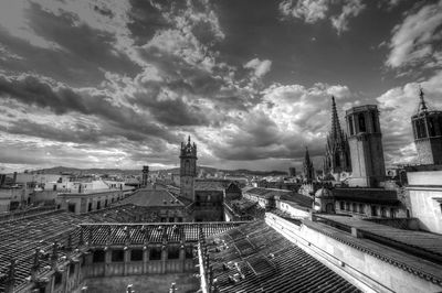 View of cityscape against cloudy sky