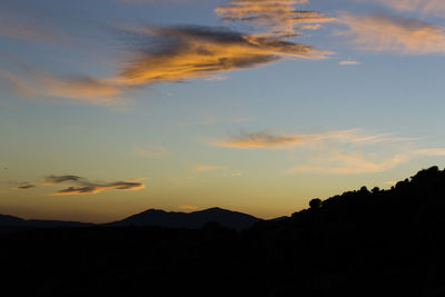 Scenic view of silhouette mountains against sky during sunset