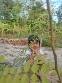 Portrait of boy looking at plants