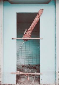 Close-up of rusty metal on wall against building