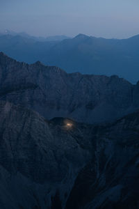 Scenic view of snowcapped mountains against sky at dusk