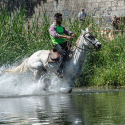 Man riding splashing water in river