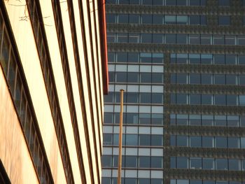 Low angle view of modern glass building in city