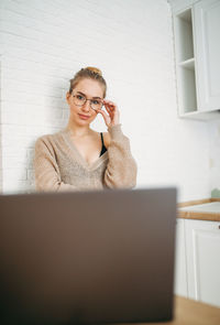 Portrait of young woman using mobile phone