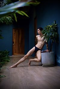 Portrait of young woman sitting on hardwood floor