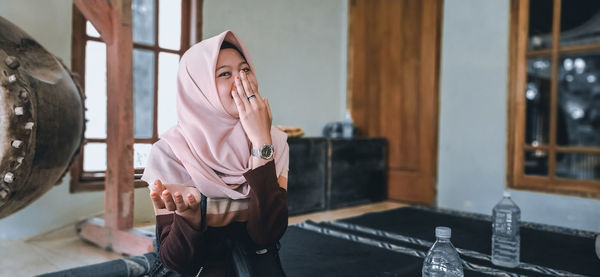 Portrait of woman standing at home