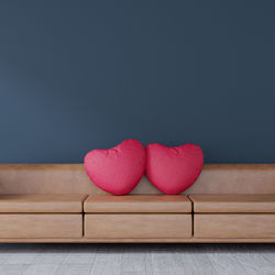 Close-up of heart shape on table against wall