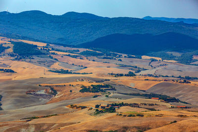 High angle view of land and mountains against sky