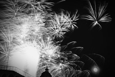 Low angle view of firework display at night