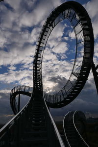 Low angle view of tiger and turtle against cloudy sky