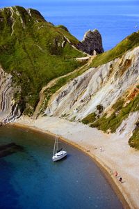 Scenic view of sea and mountains against sky