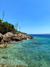 Sea against clear blue sky